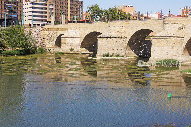 The Stone Bridge and the San Lázaro Parapet are a monumental complex built over the Ebro River in the city of Zaragoza, Spain. Work began on the current bridge in 1401, directed by Gil de Menestral, which was completed forty years later. The parapets date